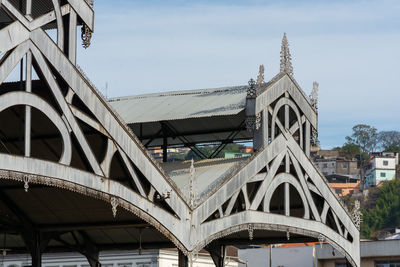 Low angle view of bridge and buildings against sky