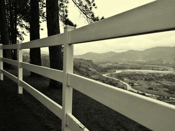 Close-up of railing against mountain range