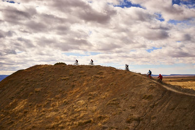Mountain bikers along a ridge in fruita, colorado.