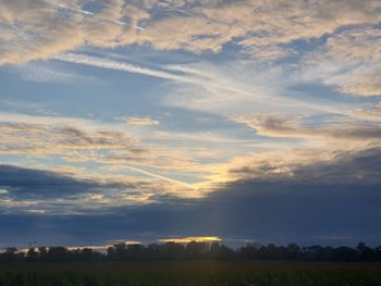 Scenic view of field against sky during sunset