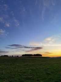 Scenic view of field against sky during sunset