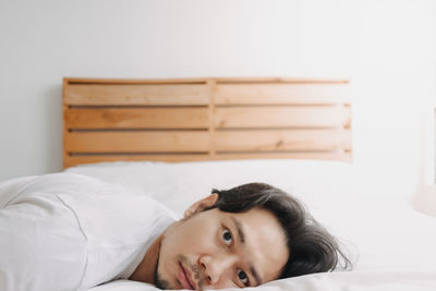 Young woman sleeping on bed at home