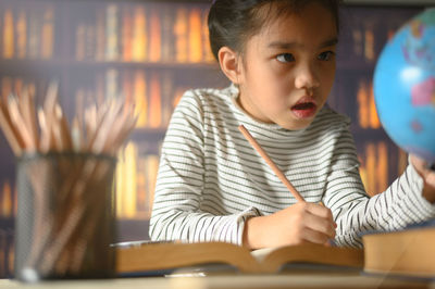 Portrait of boy sitting on table