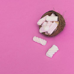 High angle view of person sleeping on pink background