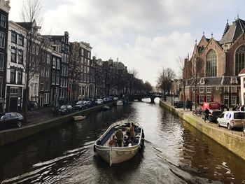 Boats in canal passing through city