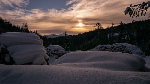 Scenic view of land against sky during sunset