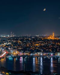 Aerial view of illuminated city buildings at night