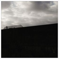 Low angle view of building against cloudy sky