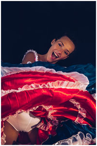 Portrait of a smiling girl lying on bed