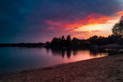 Scenic view of lake against sky at sunset