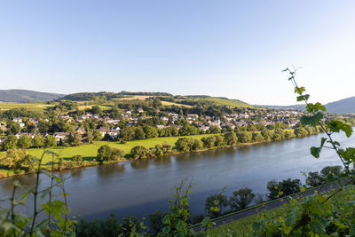 Scenic view of landscape and buildings against clear sky