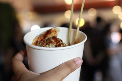 Close-up of person holding food