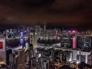 Illuminated cityscape against sky at night