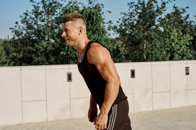 Portrait of young man exercising in gym