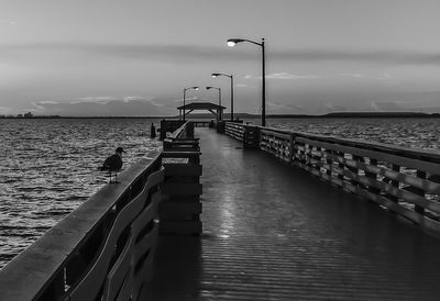 View of pier on sea against cloudy sky