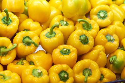 Full frame shot of yellow bell peppers for sale in market