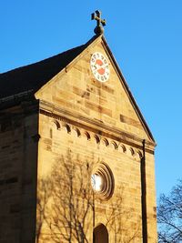 Low angle view of clock tower against clear sky