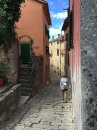 Rear view of woman walking on walkway