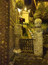 Illuminated lanterns hanging in row at night