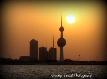 City at waterfront during sunset