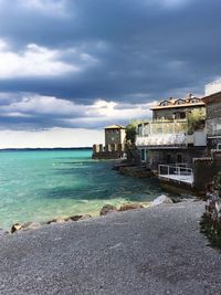 Sea and buildings against sky