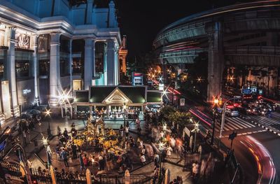 High angle view of people at erawan shrine in illuminated city