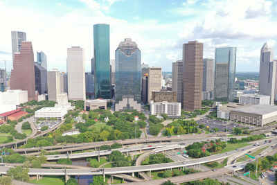 Aerial view of modern buildings in city against sky