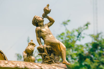 Low angle view of angel statue against sky