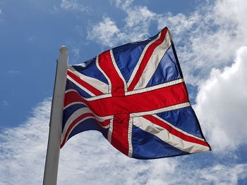 Low angle view of flags flag against sky