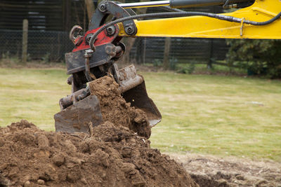 Close-up of earth mover digging field