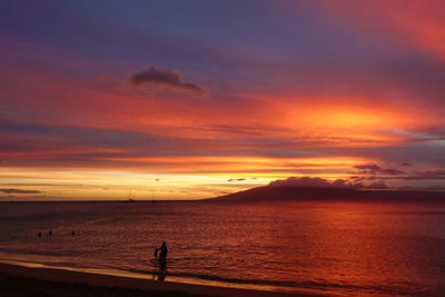 Scenic view of sea against orange sky