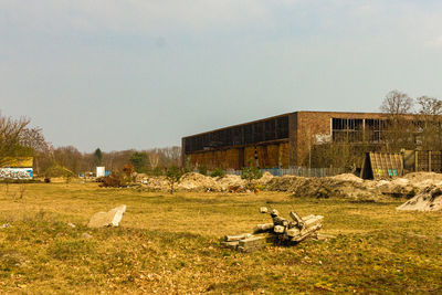 Abandoned building on field against sky