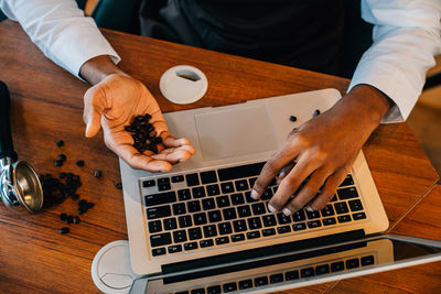 Midsection of man using laptop