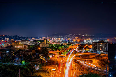 High angle view of illuminated city against sky at night