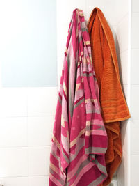 Multicolored towels hanging in a bathroom