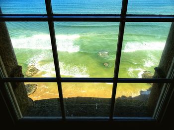 Scenic view of sea seen through glass window