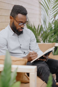 Young man using laptop while sitting at home