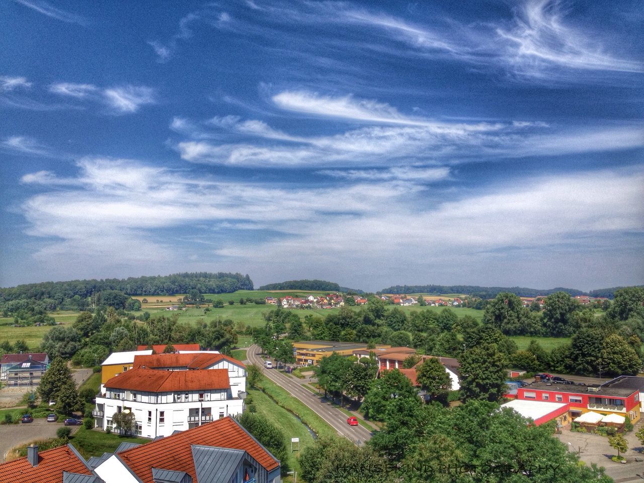 building exterior, architecture, tree, built structure, sky, house, cloud - sky, high angle view, residential structure, roof, town, cloud, residential building, residential district, cloudy, landscape, townscape, nature, scenics, day