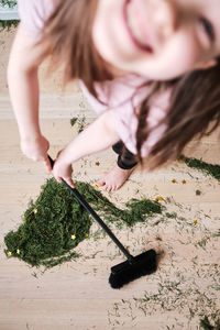 High angle view of woman holding plant