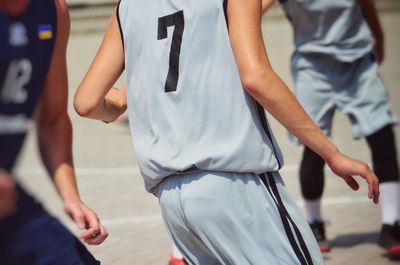 Midsection of sports player playing on court