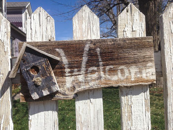 Welcome sign on old picket fence