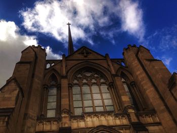 Low angle view of church against cloudy sky