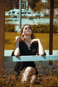 Young woman sitting outdoors