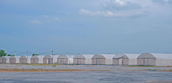 Green house on blue sky background.agricultural building for farming of vegetables