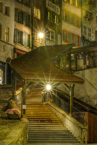 Staircase in city at night