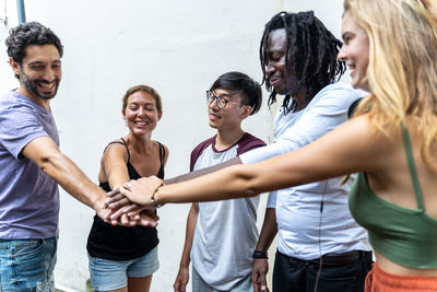Young couple standing against people