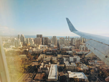 Aerial view of buildings in city against sky