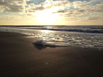 Scenic view of beach against sky during sunset