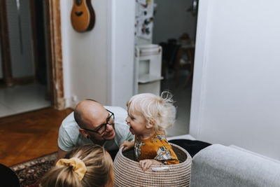 Happy toddler boy sitting in basket