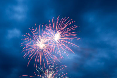 Low angle view of firework display at night